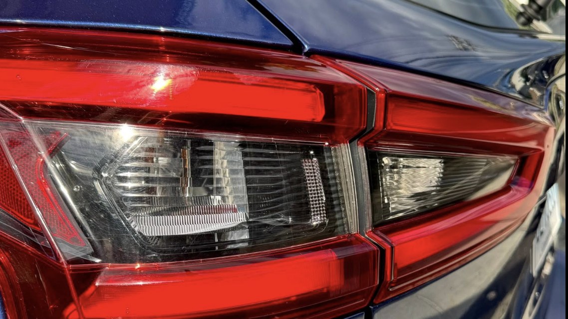 Close-up of a detailed taillight and glossy paint after an exterior detail