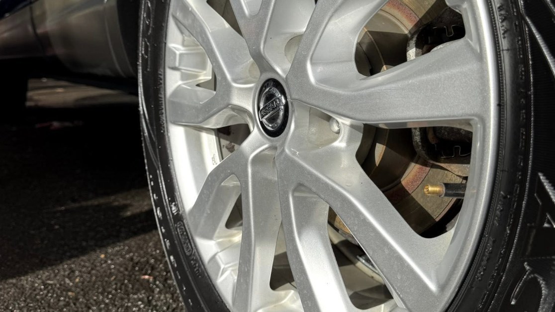 Clean, dressed wheel and tire close-up after an exterior detail