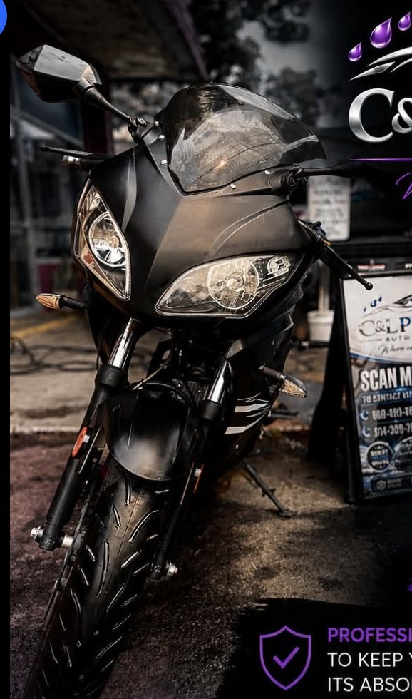 Detailed black motorcycle parked outdoors with clean paint and chrome