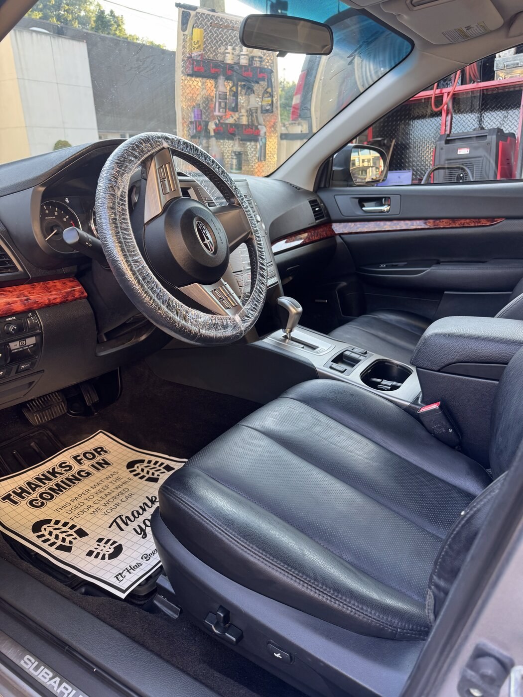 Steering wheel freshly wrapped for protection inside the C&L Prestige detailing bay